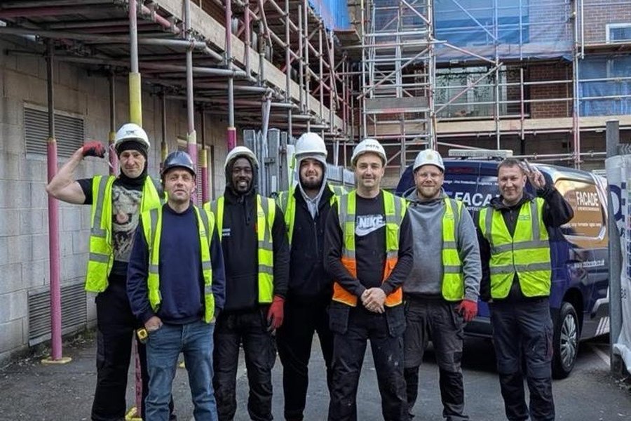 Facade installation team reviewing work from an access platform