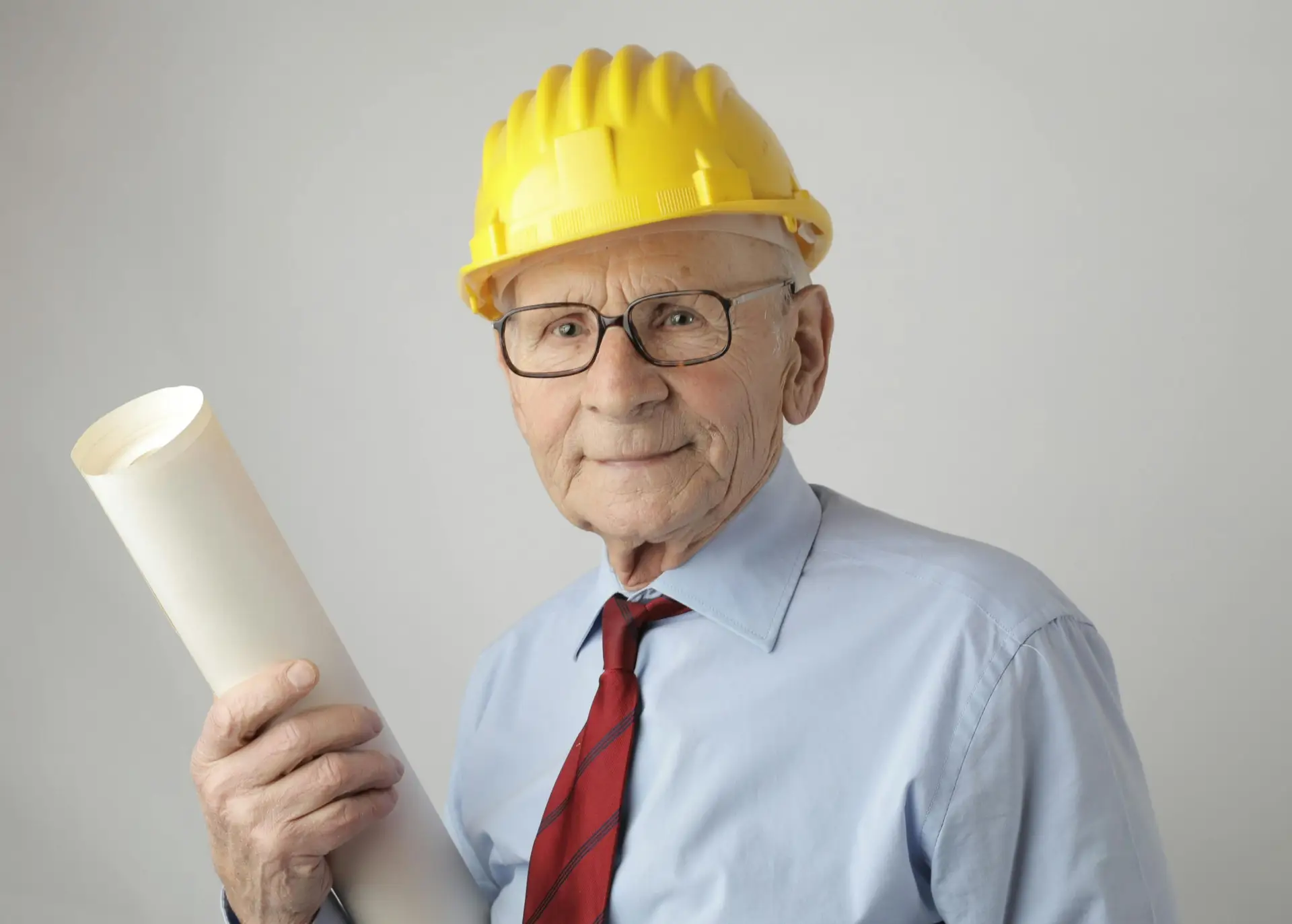 Home – Modern Recladding Projects | Cladders UK Senior engineer in safety gear holding blueprints, symbolizing experience and dedication in civil engineering.