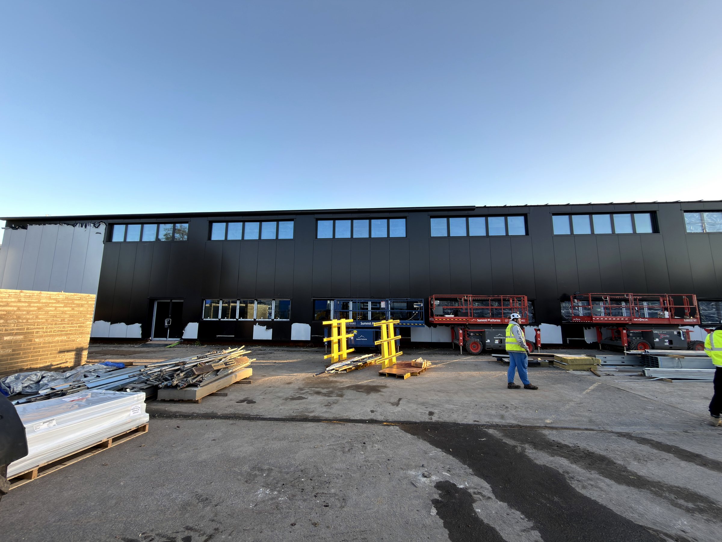 ScienceCreates OMX Bristol Kingspan panel installation with flashings, gutters and live-site access.