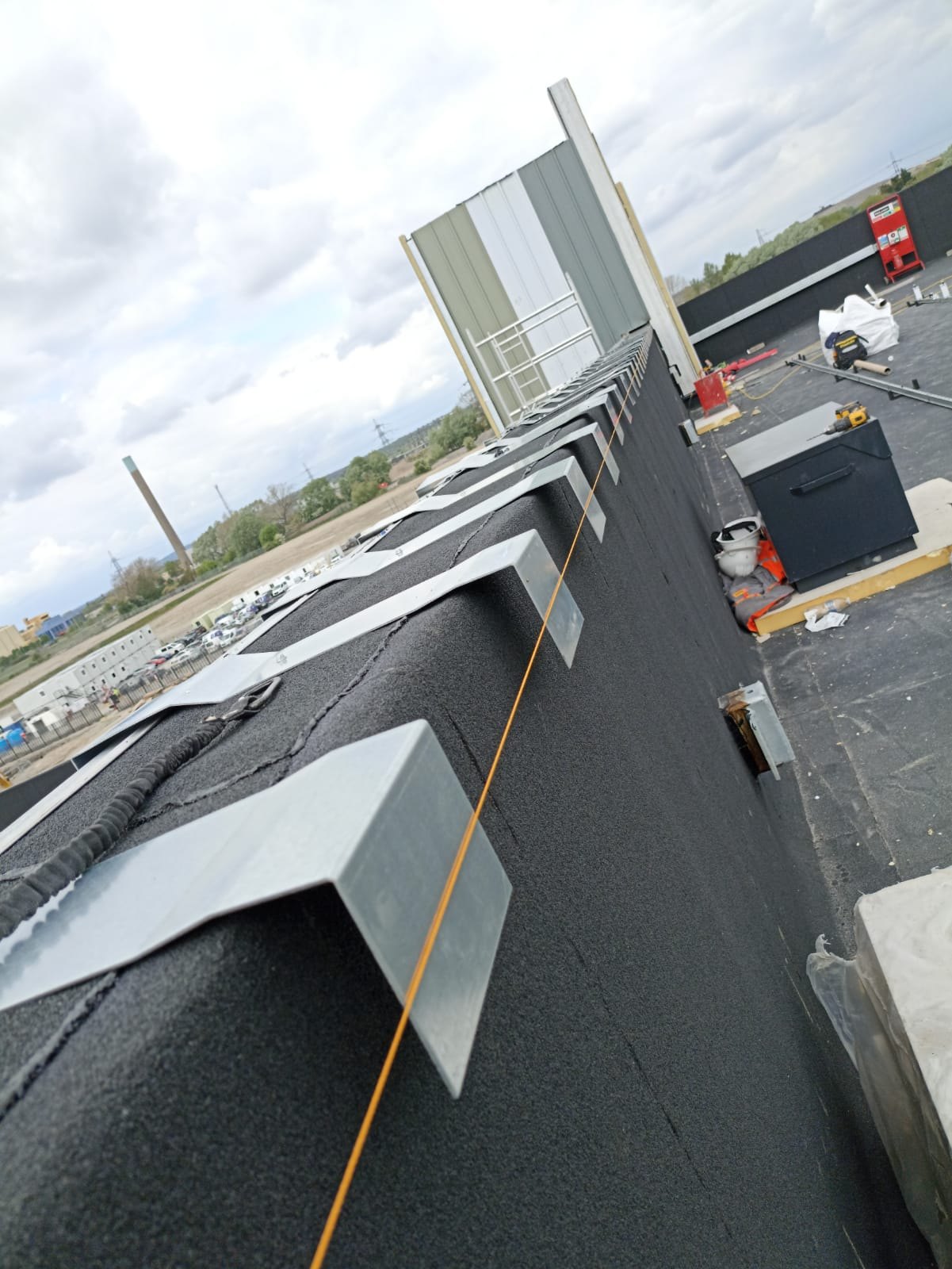 Coping and roof perimeter detail during data centre roofing works