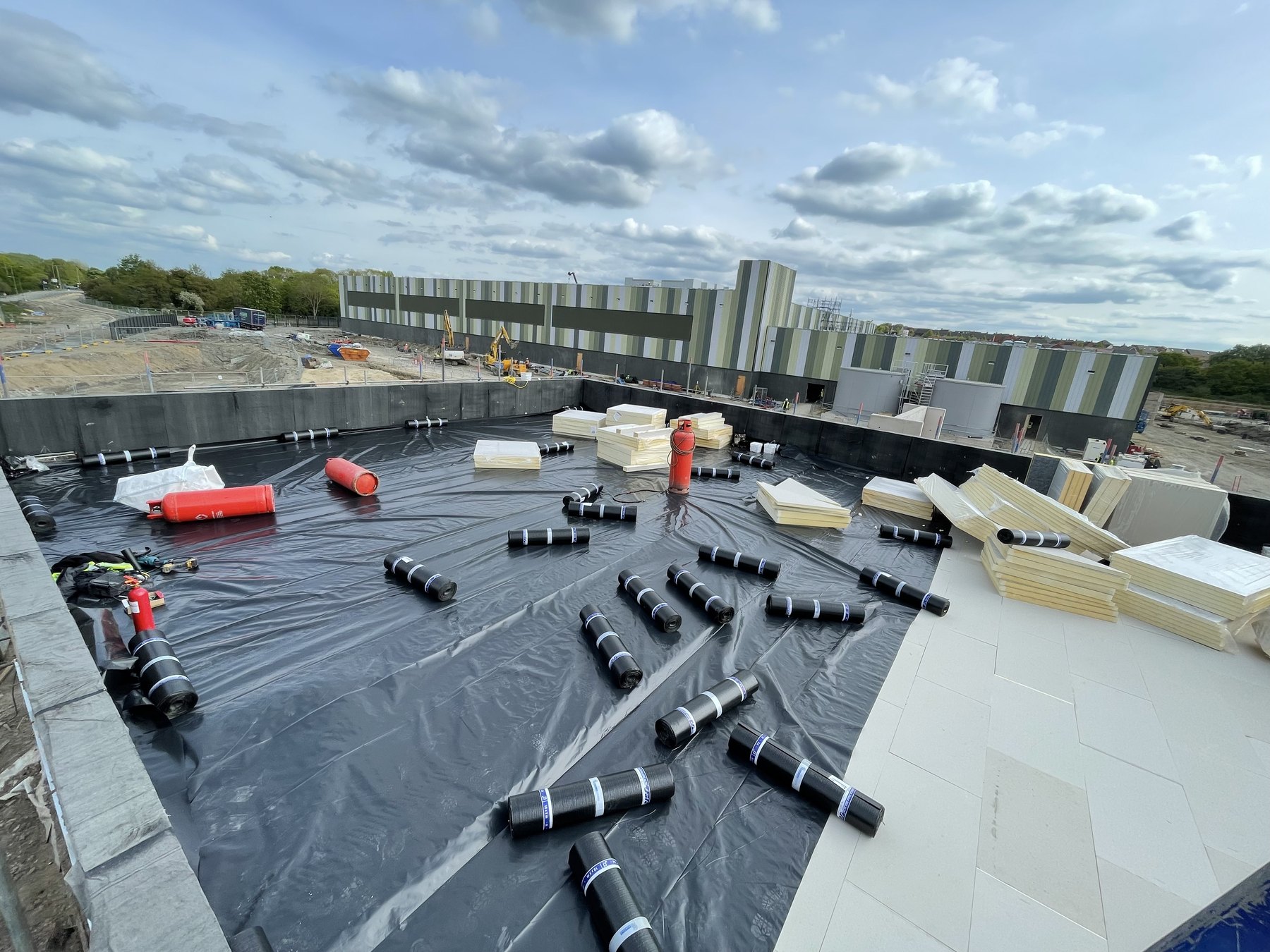 Large data centre roof installation area with coordinated roof build-up works