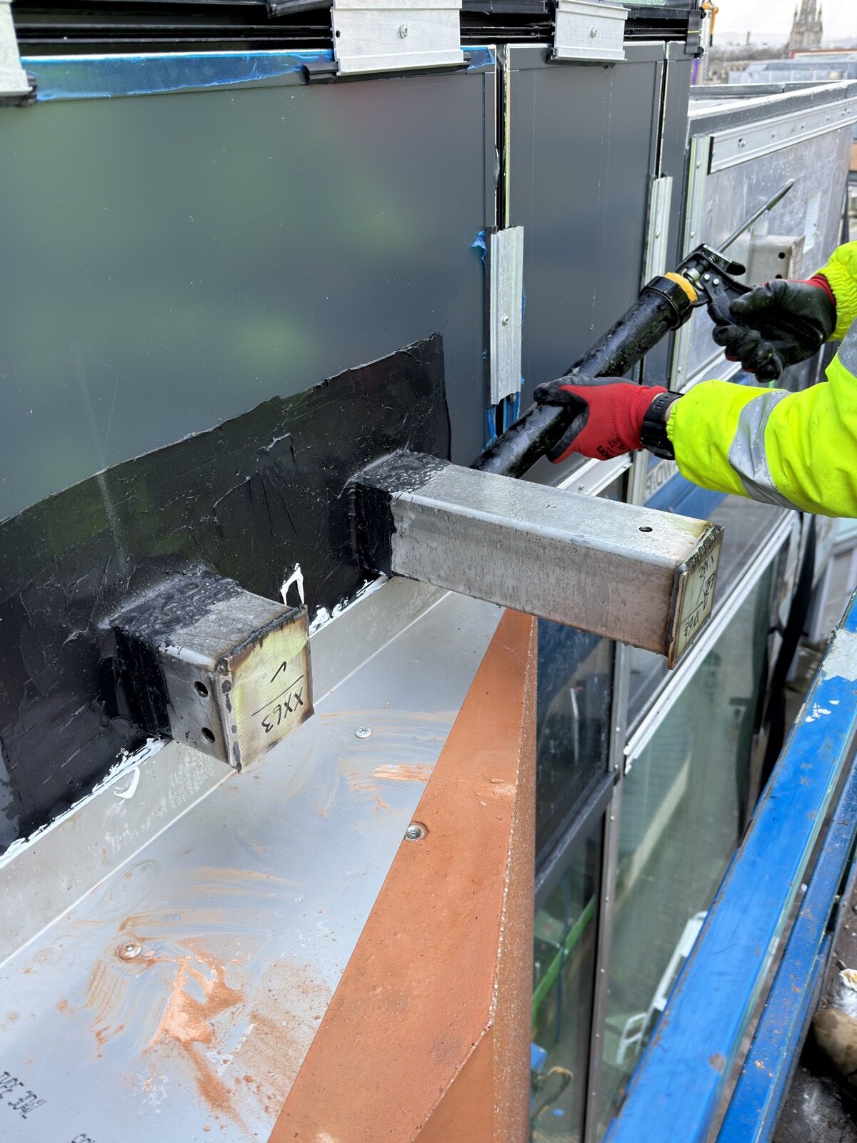 Waterproofing and bracket interface detail around GRC facade fixings