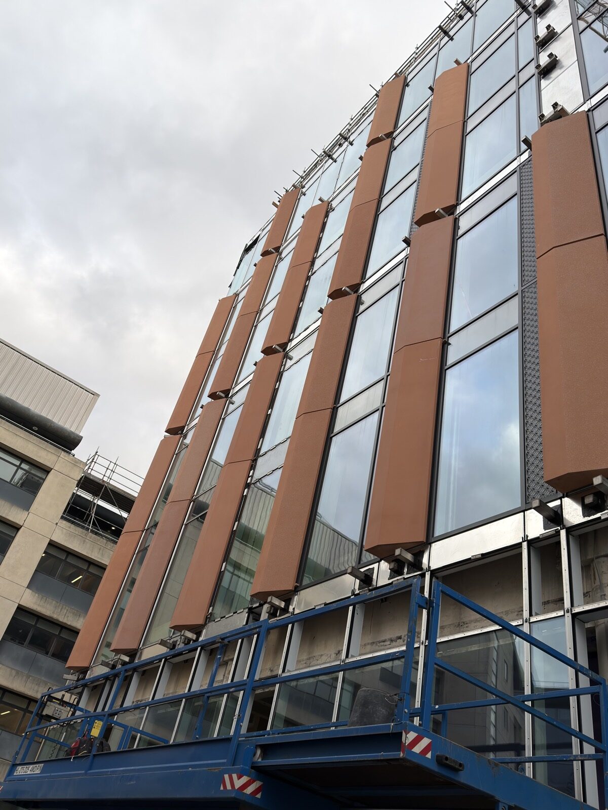 Installed GRC feature fins on modern curtain wall facade