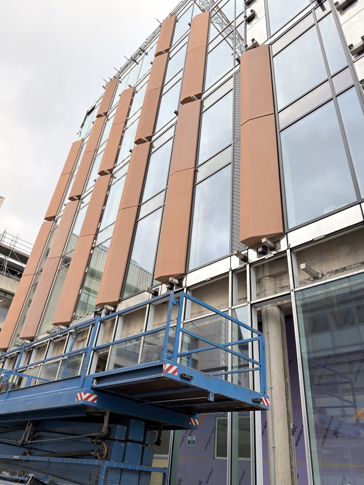Wide view of GRC feature fins installed on curtain wall facade